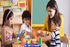 Teachers with children playing and learning at preschool